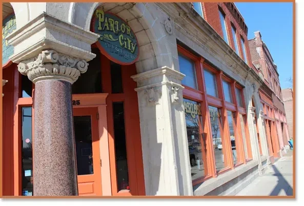 Parlor City Pub & Eatery: circular sign, stone arch, granite column, red brick.
