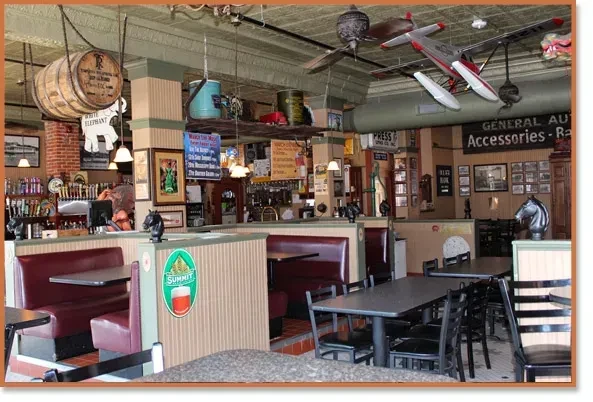 Eclectic, rustic bar interior with booth seating and a prominent bar.