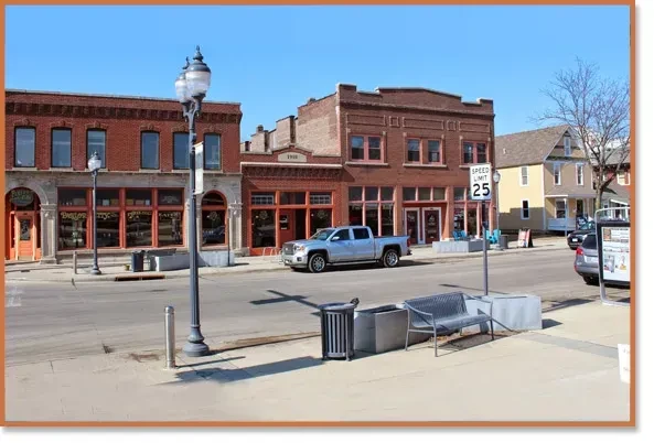 Quiet downtown street with historic brick buildings and parked truck.