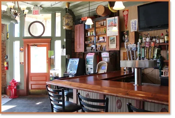 Empty rustic bar interior with long wooden counter and many beer taps.
