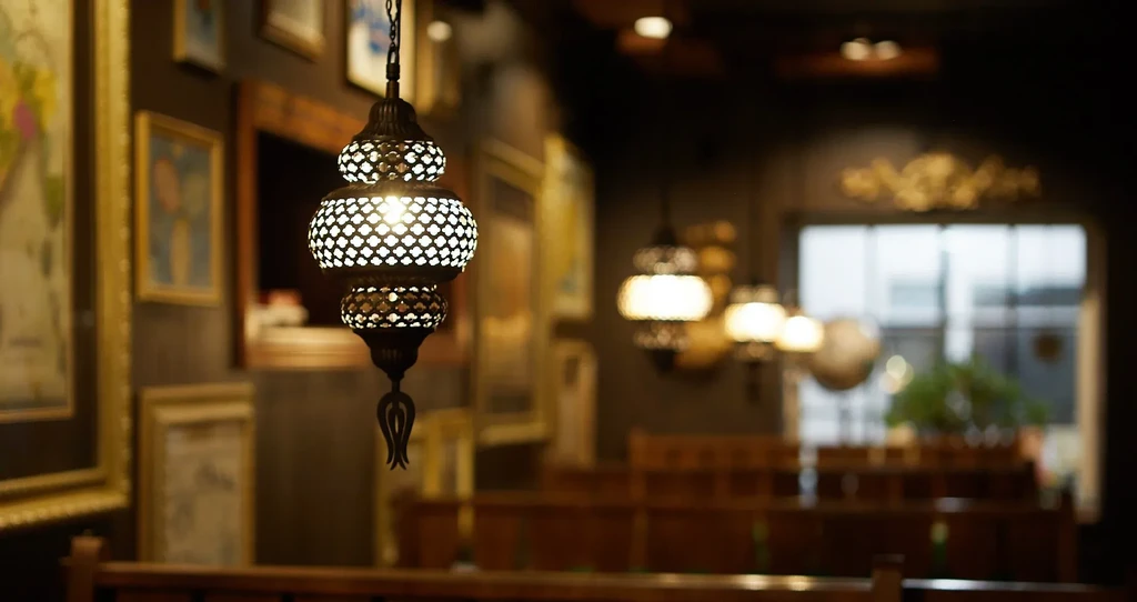 Ornate metal lantern illuminates a warm, exotic restaurant interior.