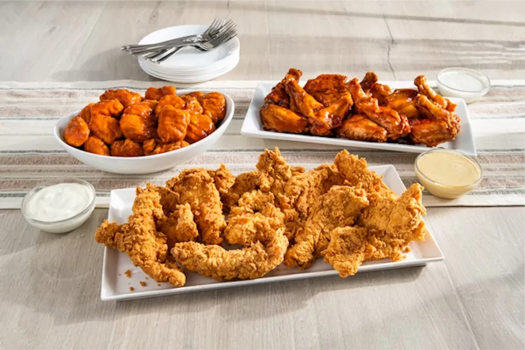 Platter of fried chicken tenders, buffalo bites, and chicken wings.