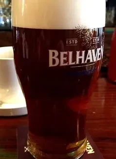 Belhaven pint of dark stout with a creamy white foam head.