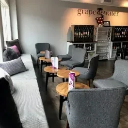"grape water" wine bar with modern seating and dispensing machines.