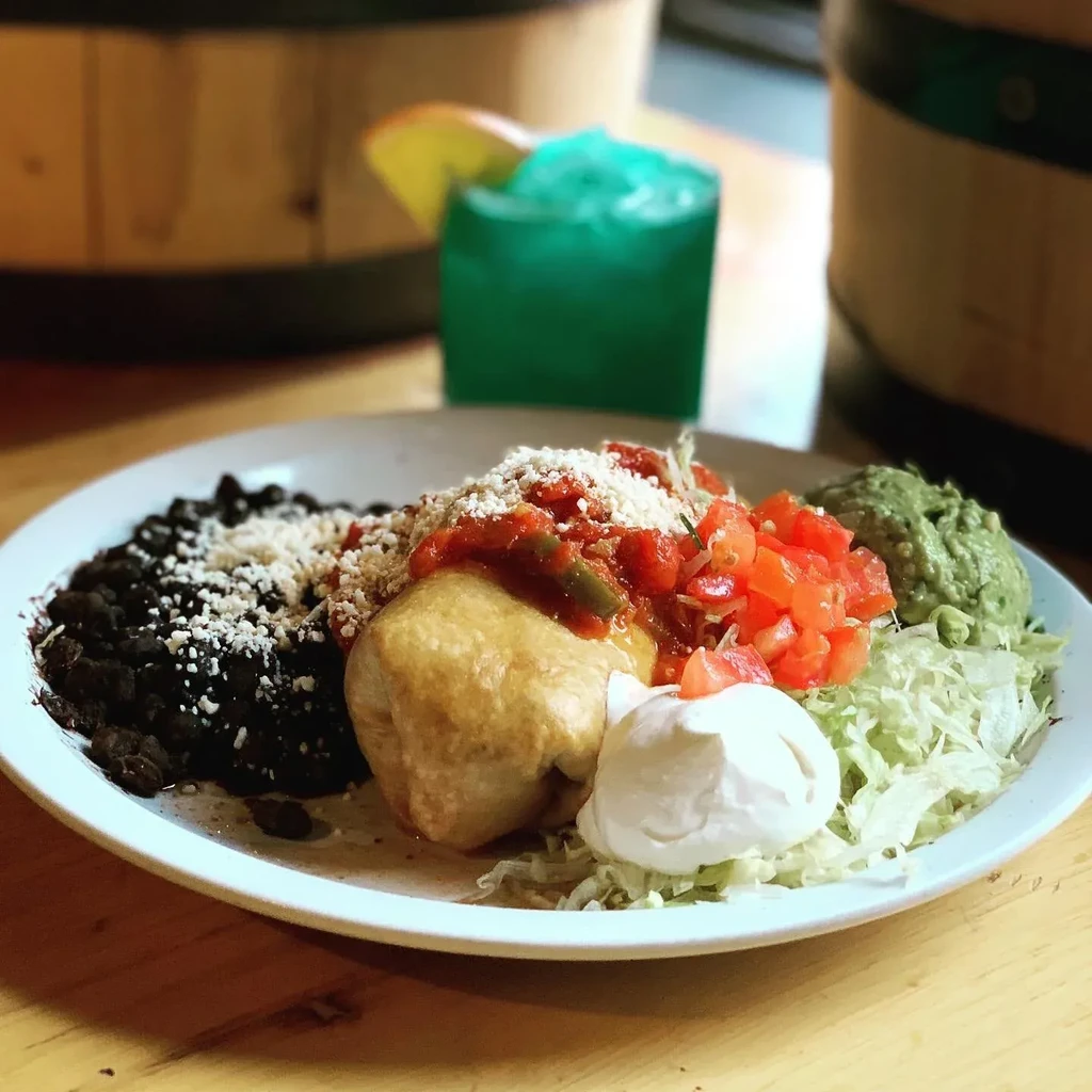 Fried entree with salsa, cheese, beans, guacamole, sour cream, and tomatoes.