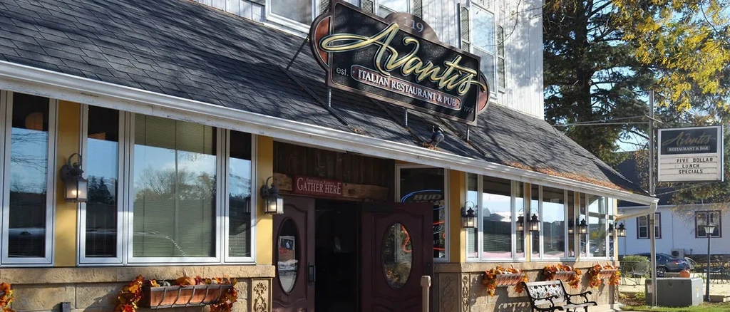 Avanti's Italian Restaurant exterior with autumn decorations on a sunny day.