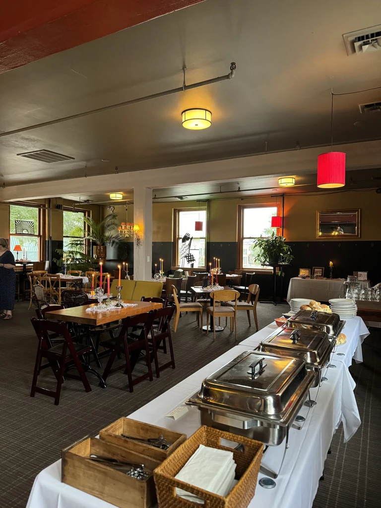 Restaurant buffet table, dining area with candles, and colorful pendant lights.