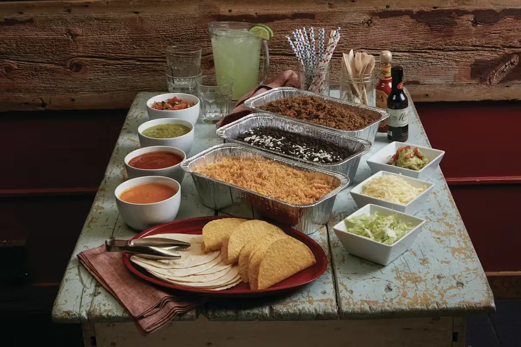 Mexican-style self-serve taco bar with fillings, toppings, and beverages.