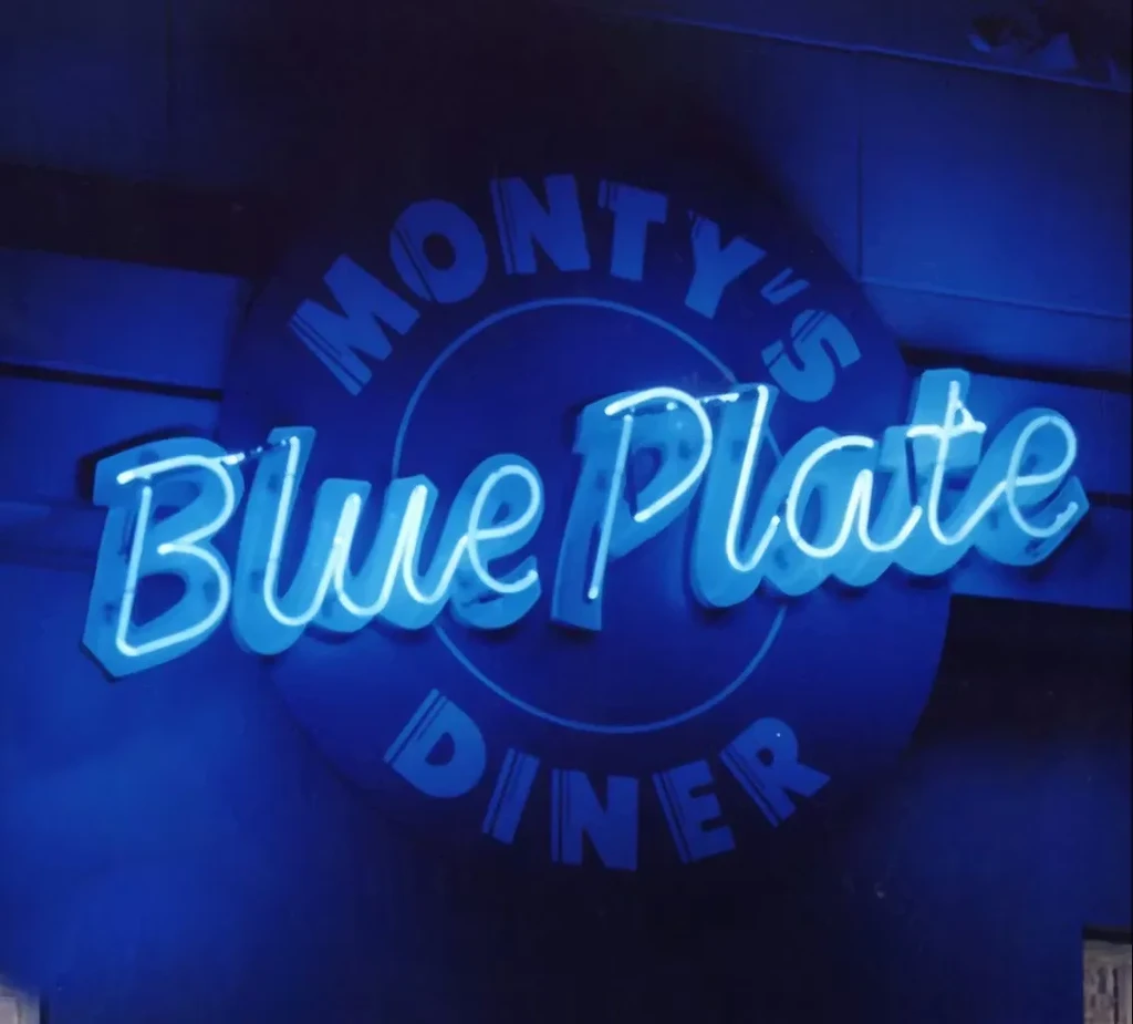 Circular electric blue neon sign for Monty's Blue Plate Diner.