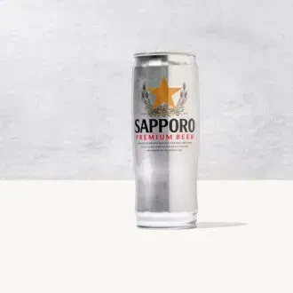 Single silver Sapporo Premium Beer can with golden star label.