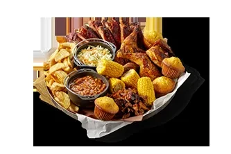Large platter of BBQ ribs, chicken, corn, fries, coleslaw, and baked beans.