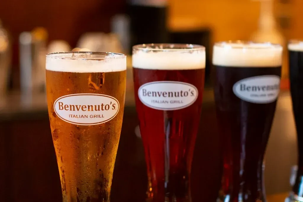 Three glasses of different beers labeled "Benvenuto's ITALIAN GRILL."