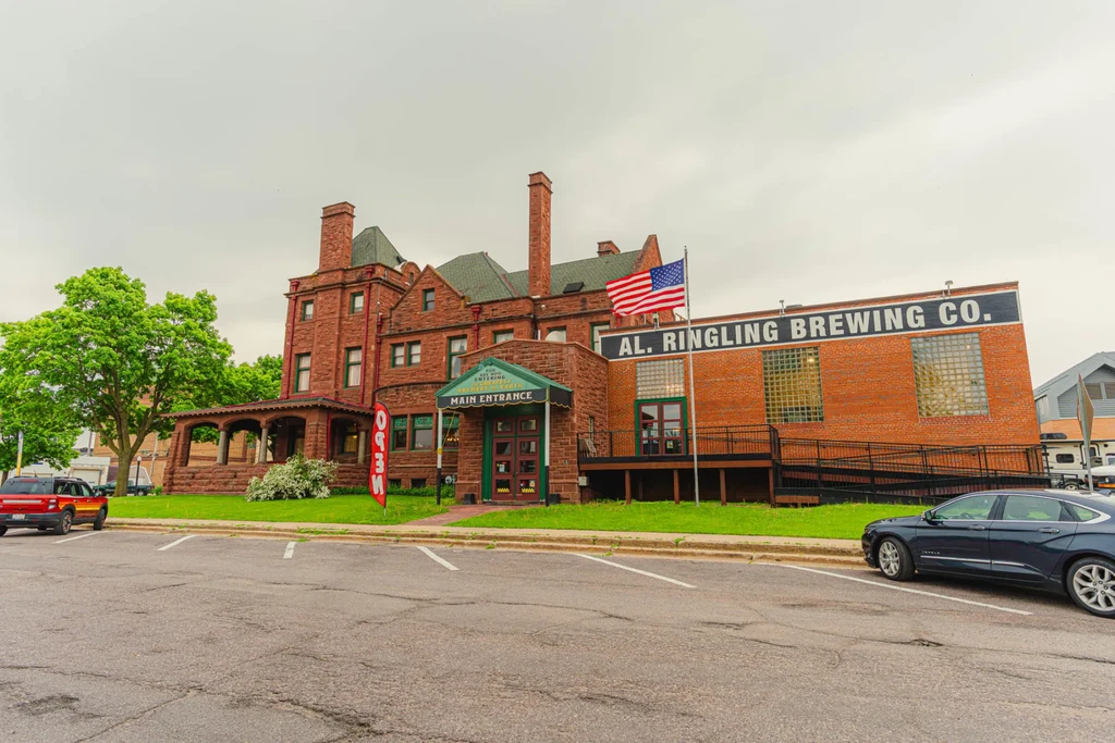 Al. Ringling Brewing Co. complex: historical mansion and industrial brick building.
