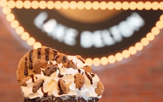 Elaborate chocolate sundae topped with whipped cream, cookies, and sprinkles.