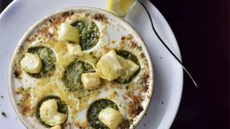 Baked escargots in herbed butter sauce with golden pastry topping.