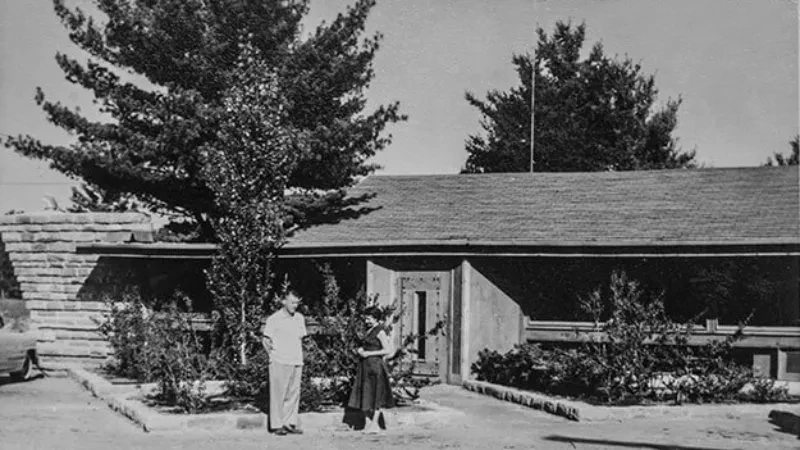 Vintage photo: mid-century commercial building, man and woman posing.