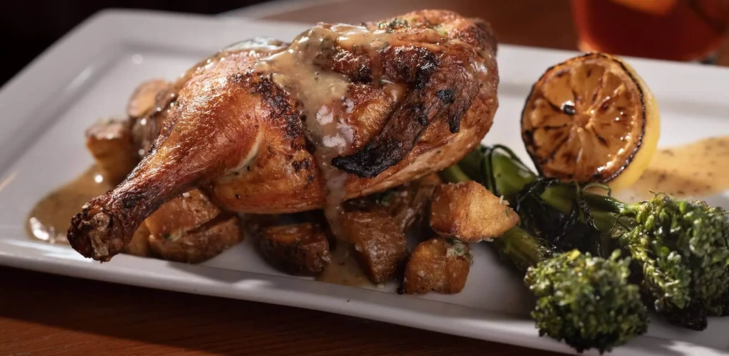 Golden roasted chicken, creamy sauce, potatoes, broccolini, grilled lemon.