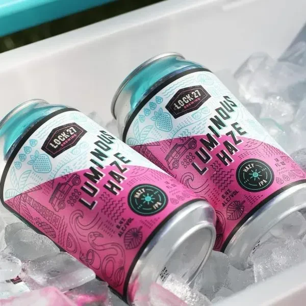 Two Lock 27 Brewing Luminous Haze Hazy IPA cans in ice.