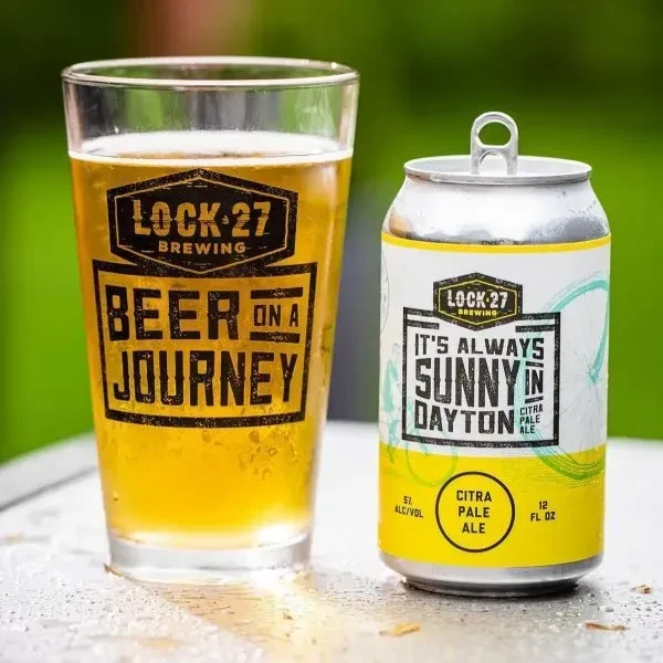 Lock-27 Brewing pint of beer and pale ale can, outdoors.