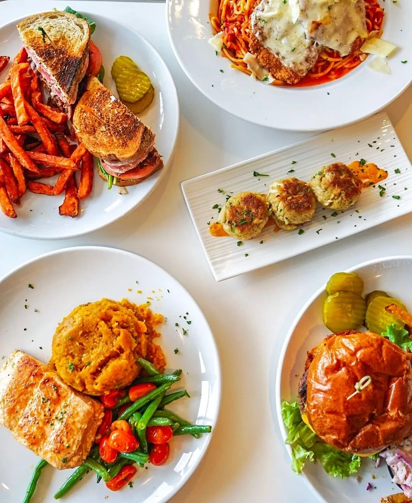 Overhead view of a table full of various restaurant dishes.