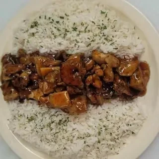 Plate of chicken in dark sauce, flanked by herb rice.