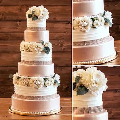 Six-tiered wedding cake with rose-gold, white, flowers, and sparkling ribbon.