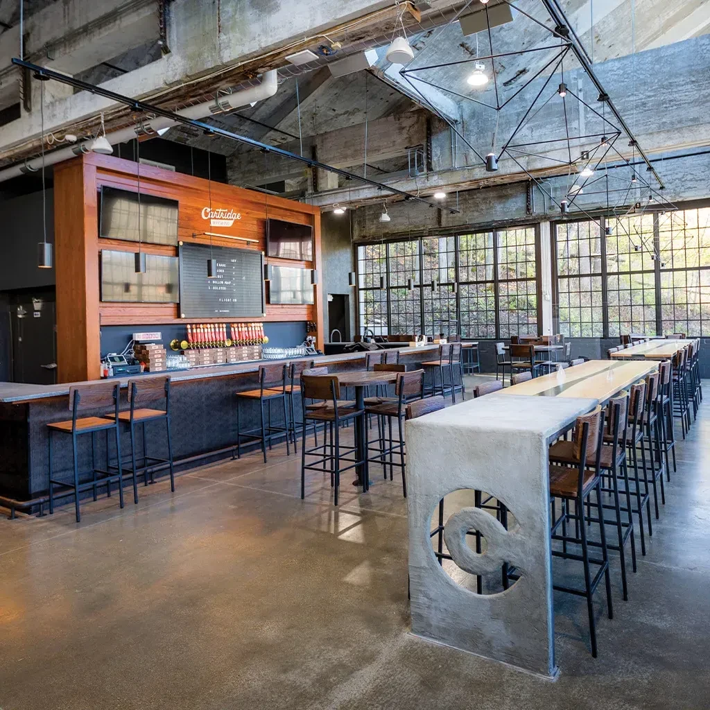 Modern Cartridge Brewing interior with industrial style bar and seating.