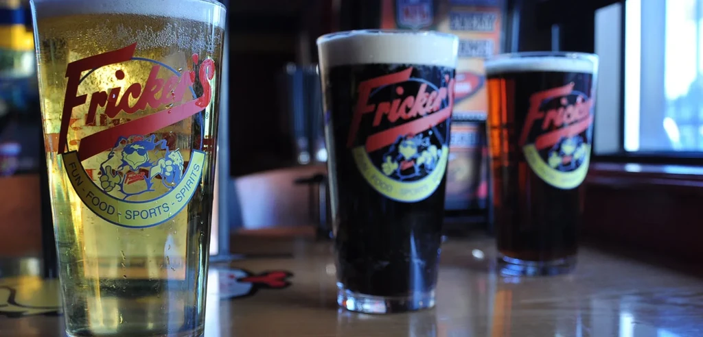 Three Fricker's branded beers: golden lager, dark stout, and amber ale.