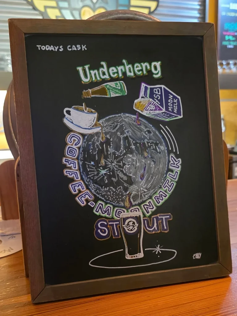 Chalkboard advertising 'Underberg Coffee Moon Milk Stout' with hand-drawn art.