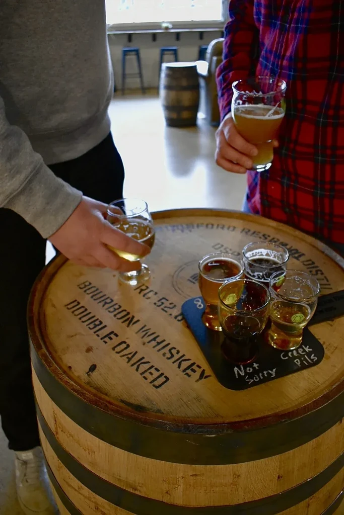 Close-up of a beer flight on a Bourbon Whiskey barrel table.
