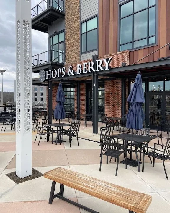 Modern HOPS & BERRY restaurant exterior with large patio seating.
