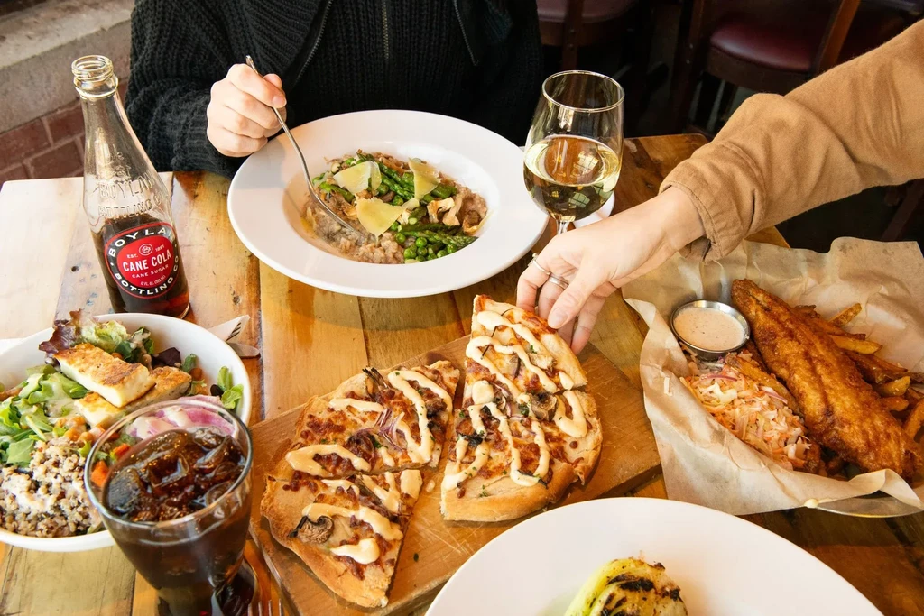 Overhead view of a restaurant table with diverse dishes and drinks.