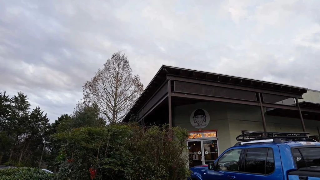 Overcast view of LUCHA TIGRE restaurant with tiger mask logo.