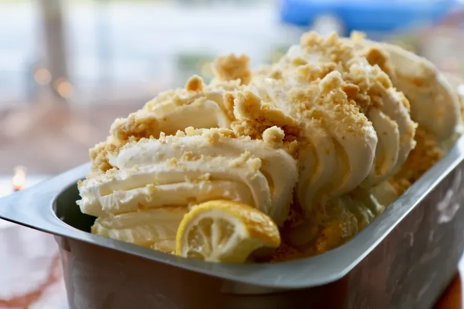 Creamy lemon dessert with golden crumbs and a fresh lemon slice.