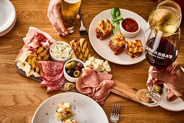 Overhead view of Carrabba's Italian charcuterie, meatballs, and drinks.