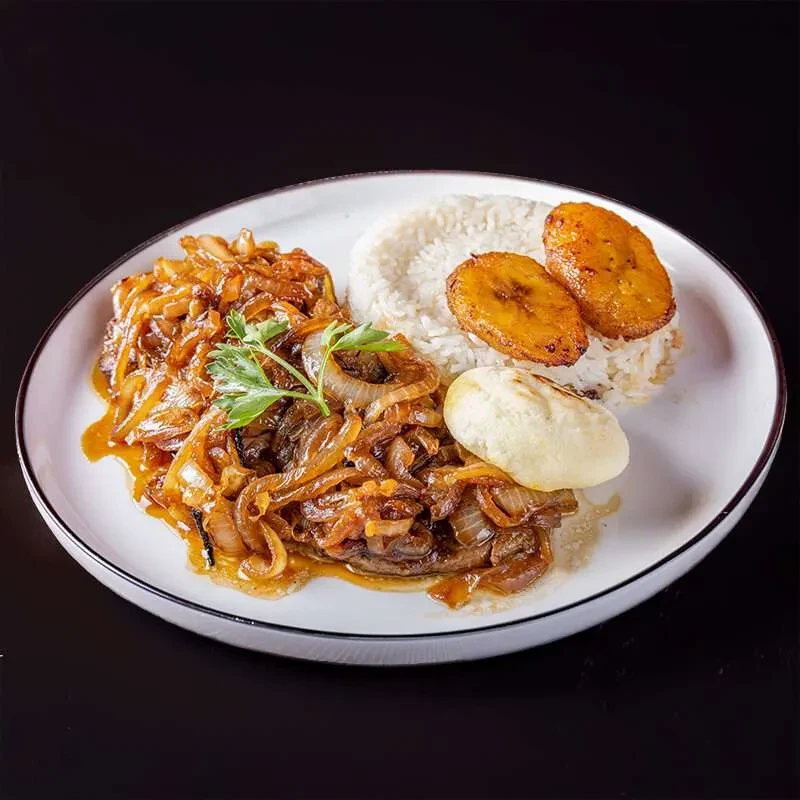 Steak and onions with rice, fried plantains, and a bun.
