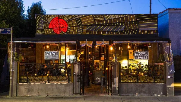 Venice Beach Wines restaurant exterior at dusk, with red target sign and patio.