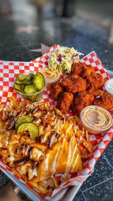Crispy fried chicken, loaded cheese fries, pickles, coleslaw, and sauces.