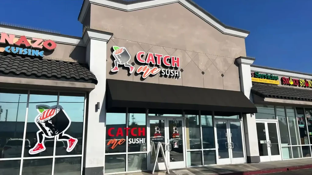 Exterior of Catch Me Sushi restaurant with its sushi roll logo.