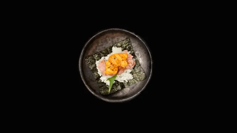 Overhead: Deconstructed Japanese handroll with nori, rice, tuna, uni, shiso.