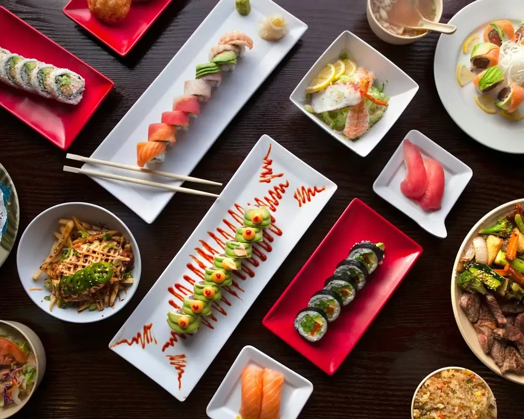 Overhead view of various Japanese and Asian food dishes.