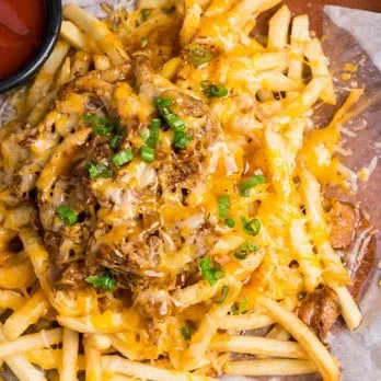 Generous loaded fries with melted cheese, pulled meat, and green onions.