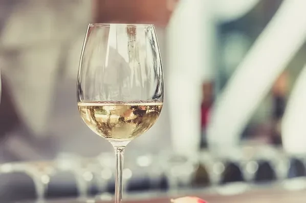 Close-up of a wine glass filled with sparkling white wine.