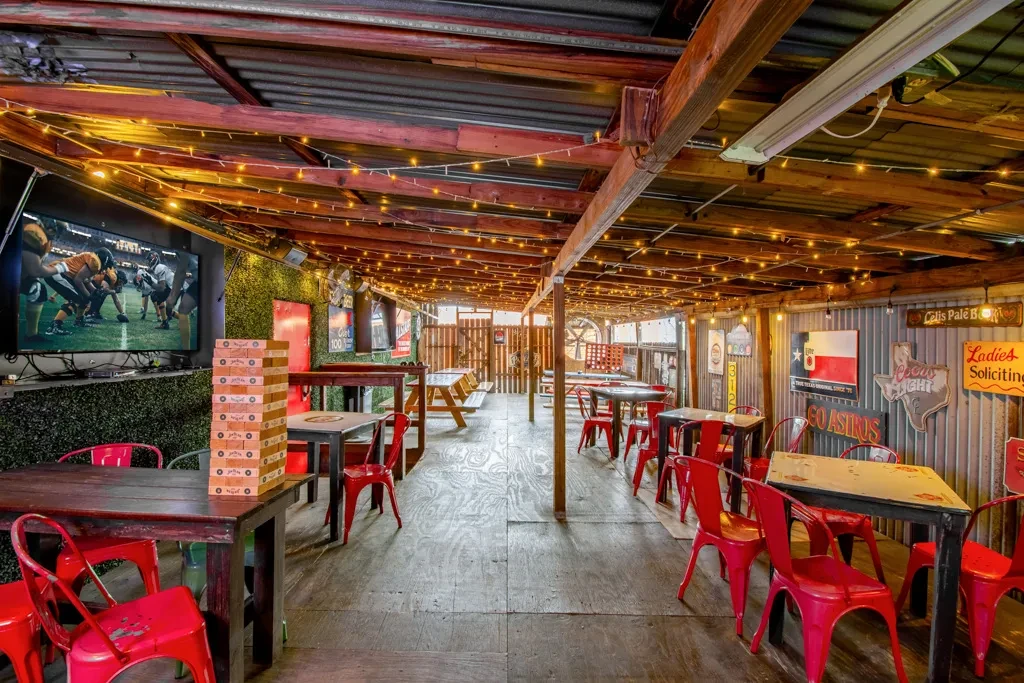 Casual restaurant or bar with rustic decor and a football game.