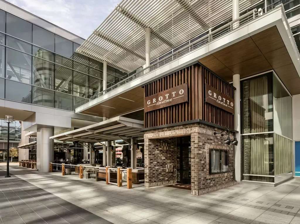 Exterior of "GROTTO downtown" restaurant with outdoor seating.