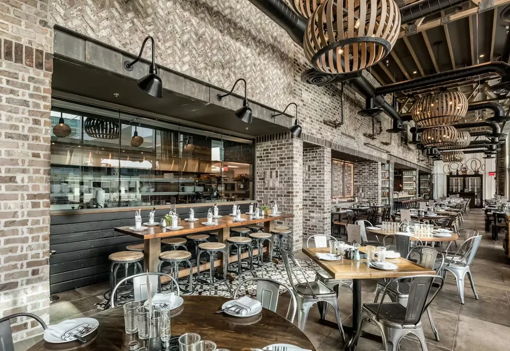 Modern industrial restaurant with exposed brick, metal, and wooden elements.