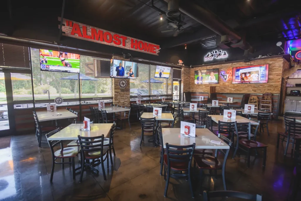 Interior of a casual restaurant or sports bar with TVs.