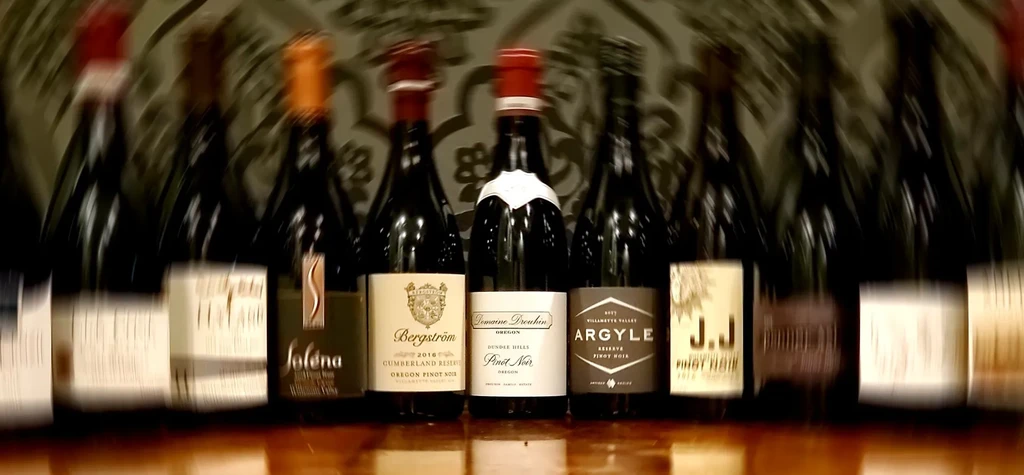 A collection of labeled wine bottles on a surface.