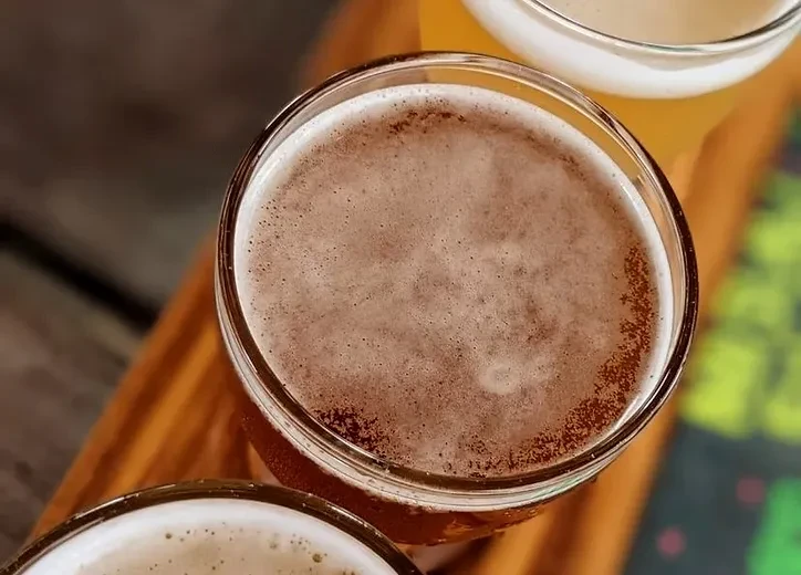 Close-up of a flight of beer with a dark amber beer.