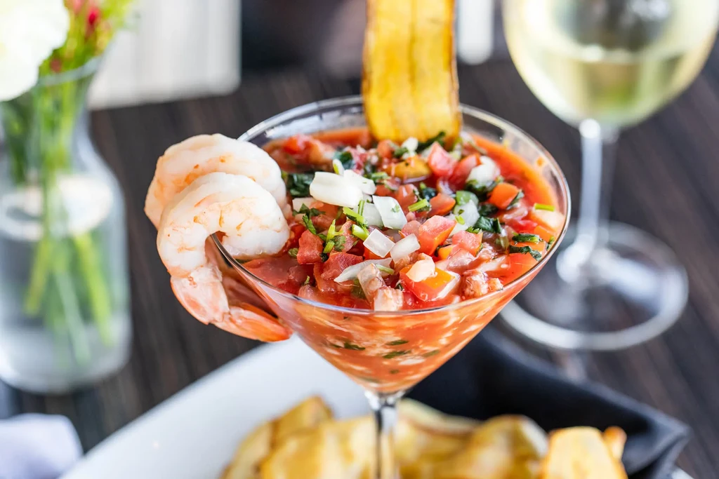 Shrimp cocktail in a martini glass with plantain chip.